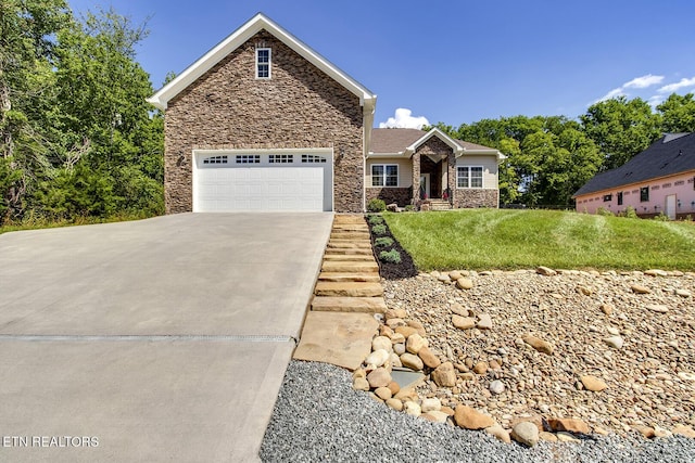 129 Dudi Trl, Vonore, TN 37885 - view of front of property with stone siding, concrete driveway, a front lawn, and a garage