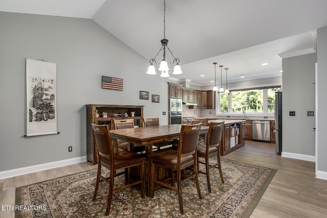 129 Dudi Trl, Vonore, TN 37885 - dining space with a chandelier, light wood finished floors, crown molding, vaulted ceiling, and recessed lighting