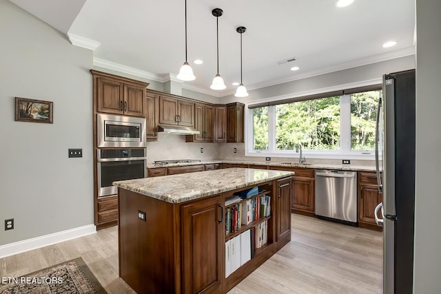 129 Dudi Trl, Vonore, TN 37885 - kitchen with appliances with stainless steel finishes, under cabinet range hood, a center island, light wood-type flooring, and decorative backsplash