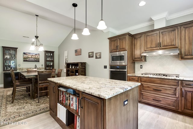 129 Dudi Trl, Vonore, TN 37885 - kitchen featuring stainless steel appliances, under cabinet range hood, tasteful backsplash, a kitchen island, and light wood-style flooring