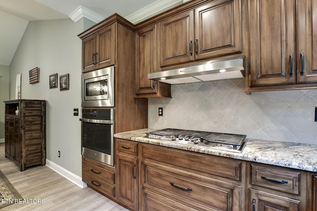 129 Dudi Trl, Vonore, TN 37885 - kitchen featuring stainless steel appliances, extractor fan, tasteful backsplash, light wood-style flooring, and light stone counters