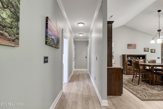 129 Dudi Trl, Vonore, TN 37885 - corridor featuring light wood finished floors, vaulted ceiling, ornamental molding, a chandelier, and healthy amount of natural light