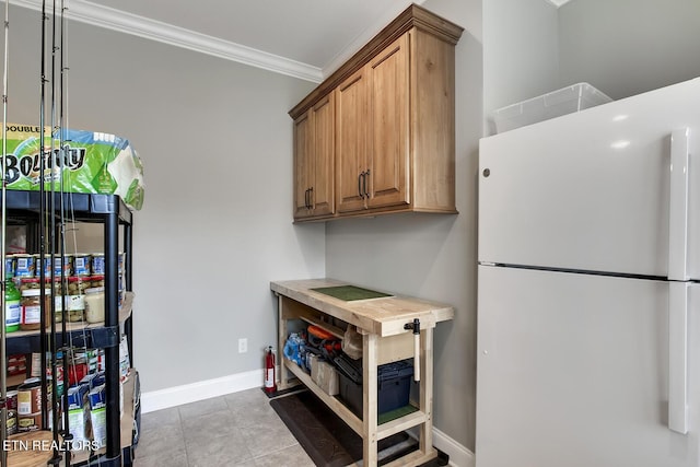 129 Dudi Trl, Vonore, TN 37885 - kitchen featuring freestanding refrigerator, crown molding, and brown cabinetry