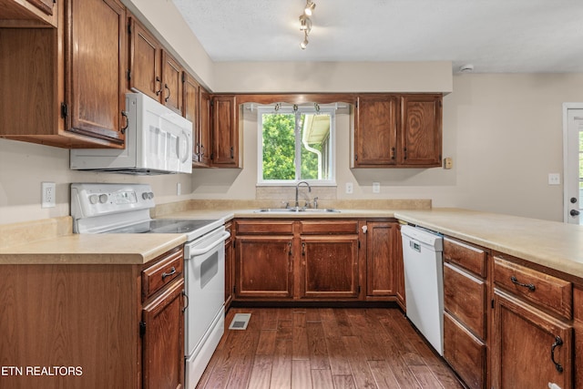 10609 Sprawls Pt, Knoxville, TN 37932 - kitchen featuring white appliances, dark wood-style flooring, light countertops, and brown cabinetry