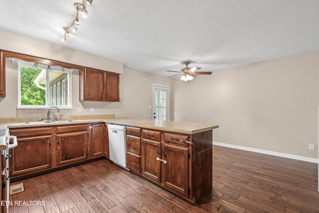 10609 Sprawls Pt, Knoxville, TN 37932 - kitchen with a peninsula, dark wood-type flooring, light countertops, a ceiling fan, and white dishwasher