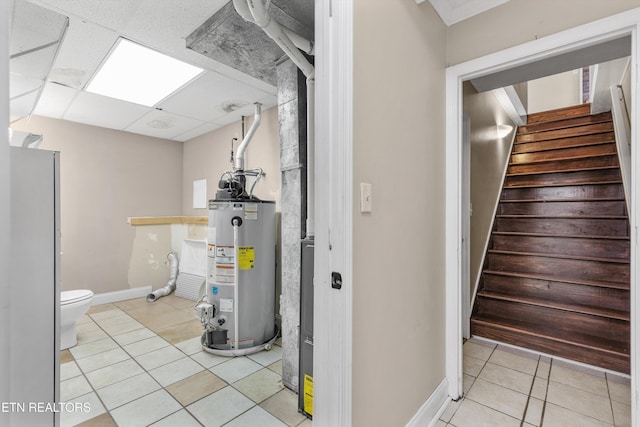 10609 Sprawls Pt, Knoxville, TN 37932 - below grade area with water heater, tile patterned flooring, stairs, and a paneled ceiling