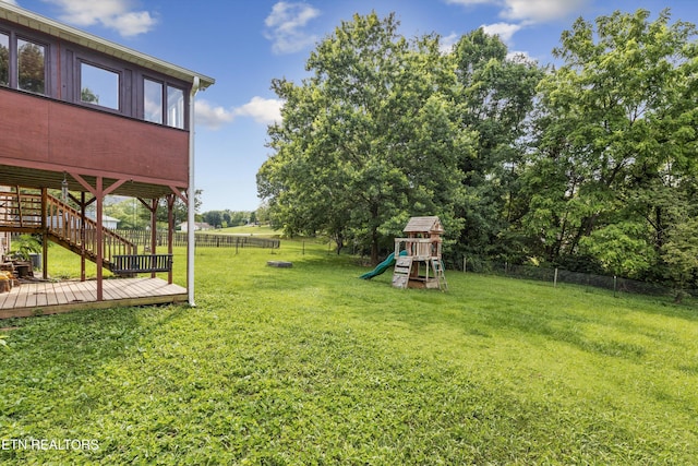 10609 Sprawls Pt, Knoxville, TN 37932 - fenced backyard featuring a playground, a wooden deck, and stairs