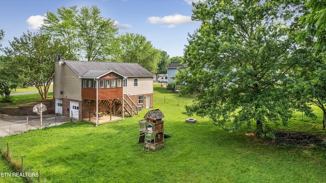 10609 Sprawls Pt, Knoxville, TN 37932 - rear view of house with a garage, concrete driveway, a chimney, stairway, and a yard