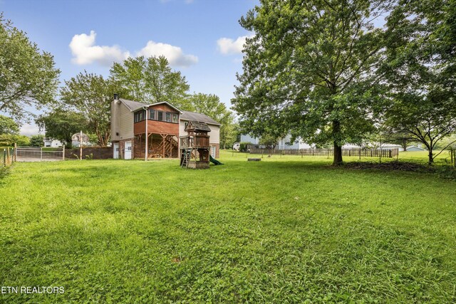 10609 Sprawls Pt, Knoxville, TN 37932 - view of yard featuring a wooden deck and an attached garage