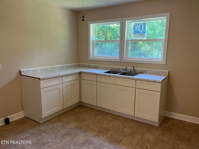 913 S Cumberland Ave, Lafollette, TN 37766 - kitchen featuring light countertops and white cabinets