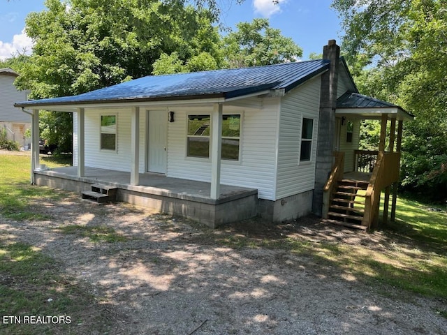 913 S Cumberland Ave, Lafollette, TN 37766 - bungalow-style house featuring a porch, a chimney, and a metal roof