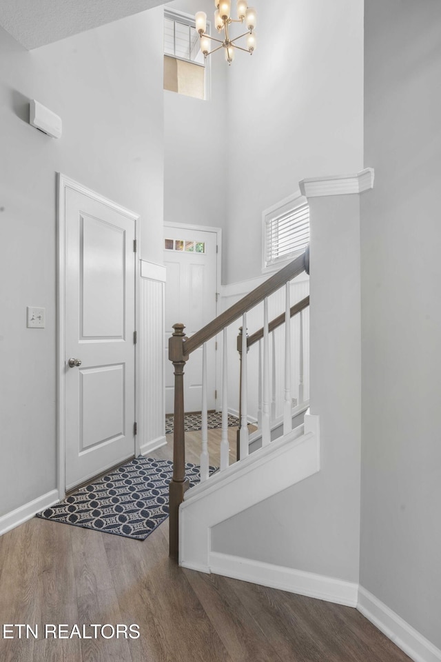 10703 Grantham Ln, Knoxville, TN 37932 - entryway featuring a chandelier, wood finished floors, a towering ceiling, healthy amount of natural light, and stairs