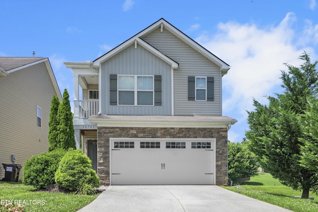 10703 Grantham Ln, Knoxville, TN 37932 - view of front of property featuring board and batten siding, stone siding, concrete driveway, and an attached garage