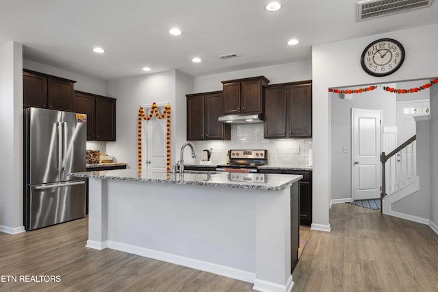10703 Grantham Ln, Knoxville, TN 37932 - kitchen featuring stainless steel appliances, dark brown cabinetry, under cabinet range hood, backsplash, and recessed lighting