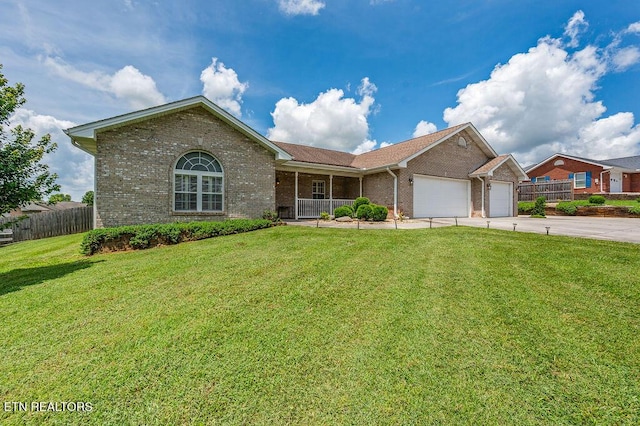 674 Southview Cir, Kodak, TN 37764 - ranch-style house with brick siding, a garage, driveway, and covered porch