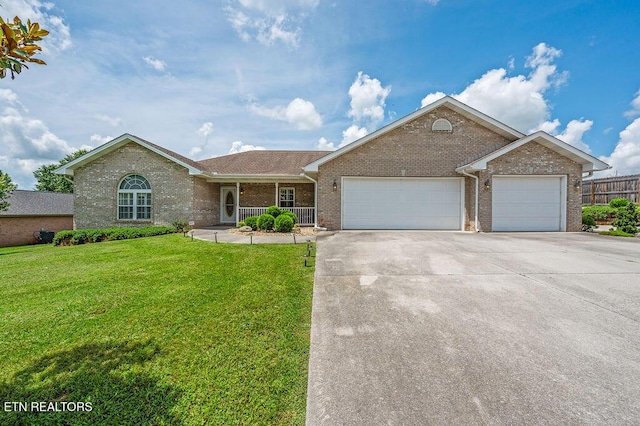 674 Southview Cir, Kodak, TN 37764 - single story home with brick siding, concrete driveway, a garage, and a porch