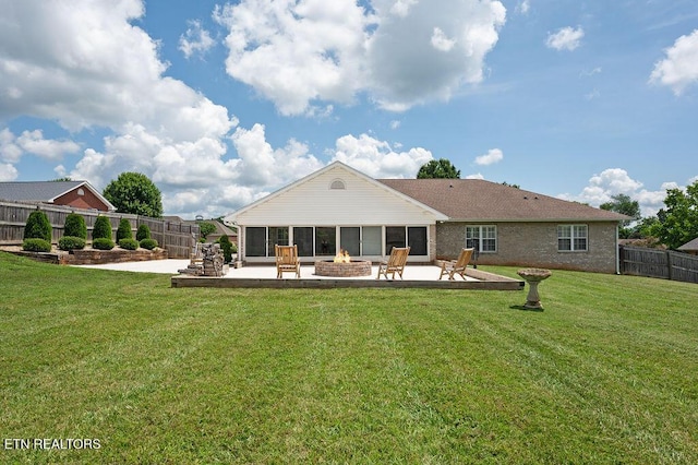 674 Southview Cir, Kodak, TN 37764 - rear view of property featuring a fire pit, a patio area, a fenced backyard, and a sunroom