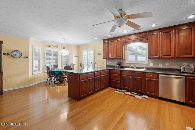 674 Southview Cir, Kodak, TN 37764 - kitchen with dishwasher, dark countertops, light wood-style flooring, a peninsula, and decorative backsplash