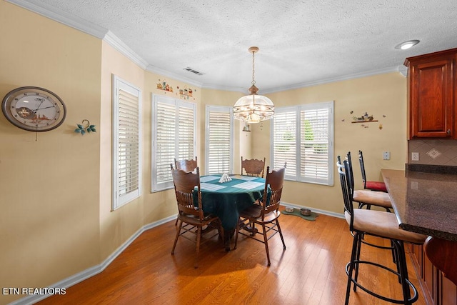 674 Southview Cir, Kodak, TN 37764 - dining area featuring a chandelier, light wood-style floors, a textured ceiling, and ornamental molding