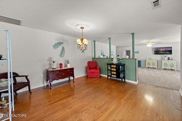 674 Southview Cir, Kodak, TN 37764 - living area with a textured ceiling, ceiling fan, light wood-style flooring, and a chandelier