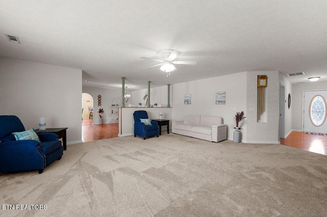 674 Southview Cir, Kodak, TN 37764 - living room featuring carpet, a ceiling fan, arched walkways, and a textured ceiling
