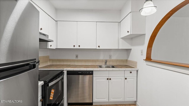 5709 Lyons View Pike Unit 4307, Knoxville, TN 37919 - kitchen featuring stainless steel appliances, under cabinet range hood, white cabinets, arched walkways, and tile counters