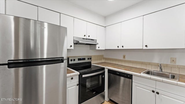 5709 Lyons View Pike Unit 4307, Knoxville, TN 37919 - kitchen featuring stainless steel appliances, under cabinet range hood, white cabinetry, and tile counters