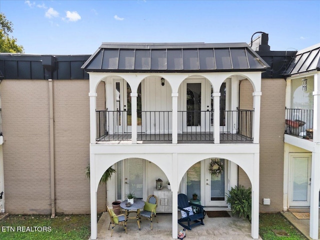5709 Lyons View Pike Unit 4307, Knoxville, TN 37919 - rear view of house featuring a standing seam roof, french doors, a balcony, and a metal roof