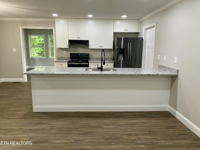506 Snead Dr, Crossville, TN 38572 - kitchen with black range with electric cooktop, stainless steel fridge, under cabinet range hood, crown molding, and white cabinets