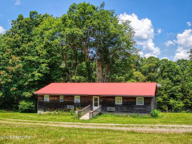 3636 Pickett Park Hwy, Jamestown, TN 38556 - view of front of property with a front yard, a metal roof, and a wooded view