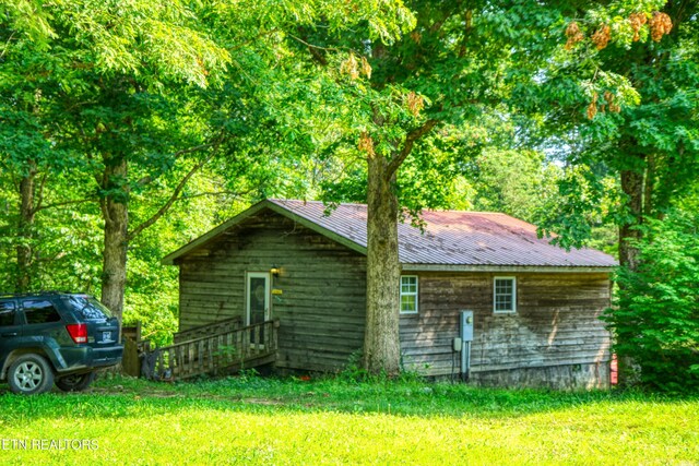 3636 Pickett Park Hwy, Jamestown, TN 38556 - view of side of property with a metal roof, a lawn, and crawl space