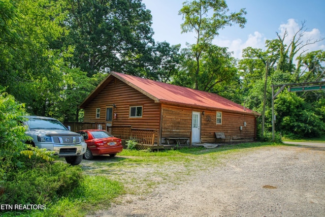 3636 Pickett Park Hwy, Jamestown, TN 38556 - view of side of home featuring faux log siding, a wooden deck, and a metal roof