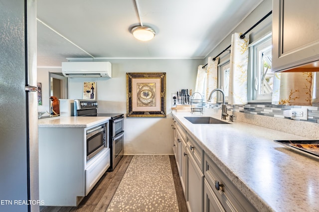 1595 Wa Ni Village Rd, Rutledge, TN 37861 - kitchen featuring a wall mounted AC, stainless steel appliances, light countertops, crown molding, and backsplash