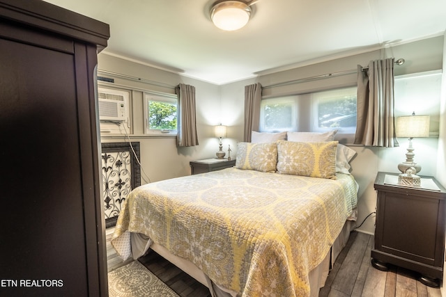 1595 Wa Ni Village Rd, Rutledge, TN 37861 - bedroom featuring hardwood / wood-style flooring, ornamental molding, and an AC wall unit