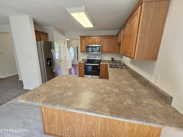209 Cherokee Trl, Seymour, TN 37865 - kitchen with stainless steel appliances, a peninsula, brown cabinets, and light countertops