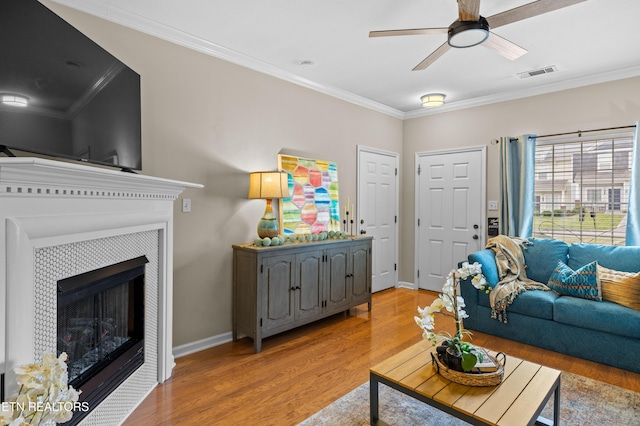 10867 Carpenter Run Ln Unit 44, Knoxville, TN 37932 - living room with ornamental molding, light wood finished floors, a ceiling fan, and a tile fireplace