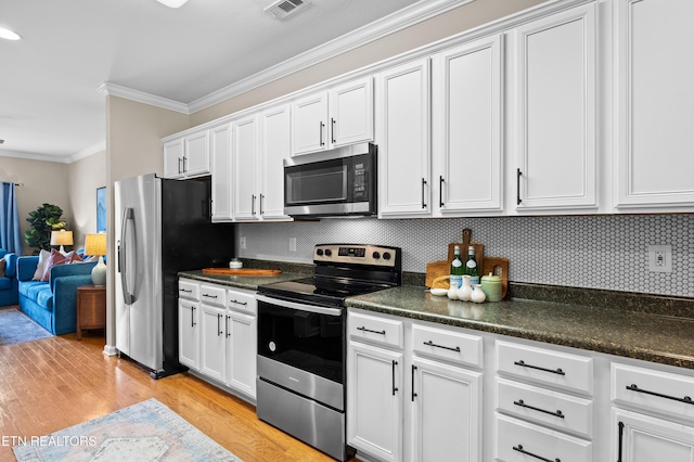 10867 Carpenter Run Ln Unit 44, Knoxville, TN 37932 - kitchen with appliances with stainless steel finishes, ornamental molding, dark countertops, light wood-type flooring, and tasteful backsplash