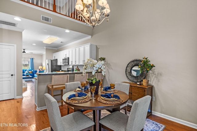10867 Carpenter Run Ln Unit 44, Knoxville, TN 37932 - dining space with crown molding, light wood-type flooring, a chandelier, and recessed lighting
