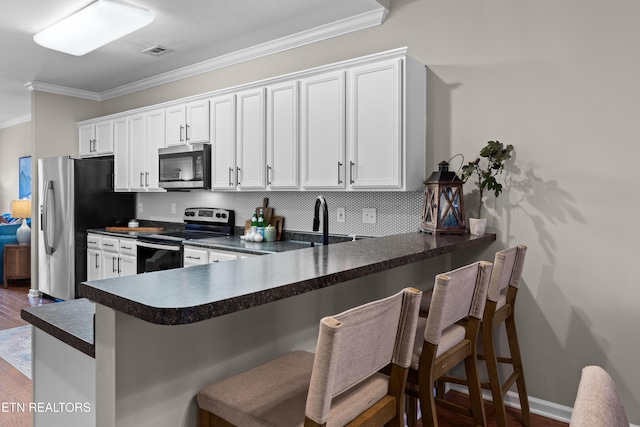 10867 Carpenter Run Ln Unit 44, Knoxville, TN 37932 - kitchen with appliances with stainless steel finishes, crown molding, dark countertops, dark wood-style floors, and decorative backsplash