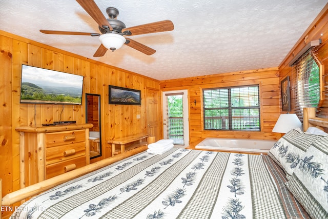 1507 Boo Boos Way, Sevierville, TN 37862 - bedroom with wooden walls, access to exterior, a textured ceiling, ceiling fan, and ornamental molding