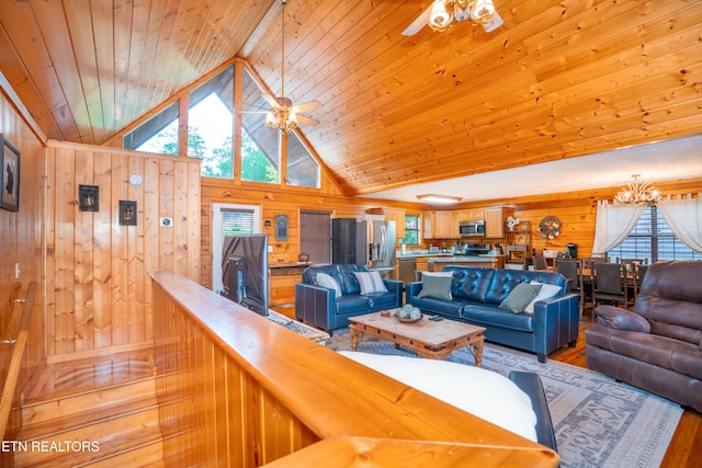 1507 Boo Boos Way, Sevierville, TN 37862 - living area with healthy amount of natural light, wood walls, a ceiling fan, wood ceiling, and light wood-style flooring