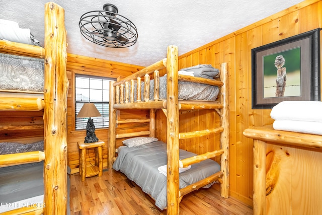 1507 Boo Boos Way, Sevierville, TN 37862 - bedroom featuring wood finished floors, rustic walls, and a textured ceiling