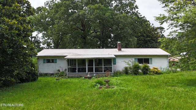 393 SW Sim Goodwin Rd, Mcdonald, TN 37353 - rear view of property featuring a sunroom, a metal roof, and a chimney