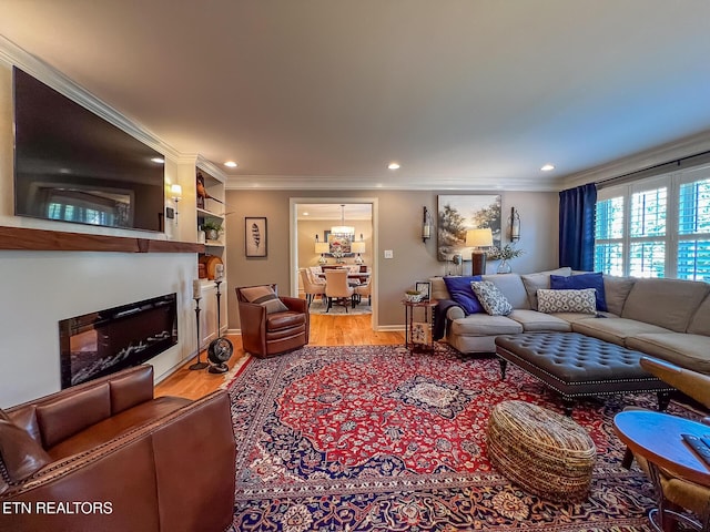 12218 Torrey Pines Pt, Knoxville, TN 37934 - living room with light wood-type flooring, ornamental molding, a glass covered fireplace, and recessed lighting