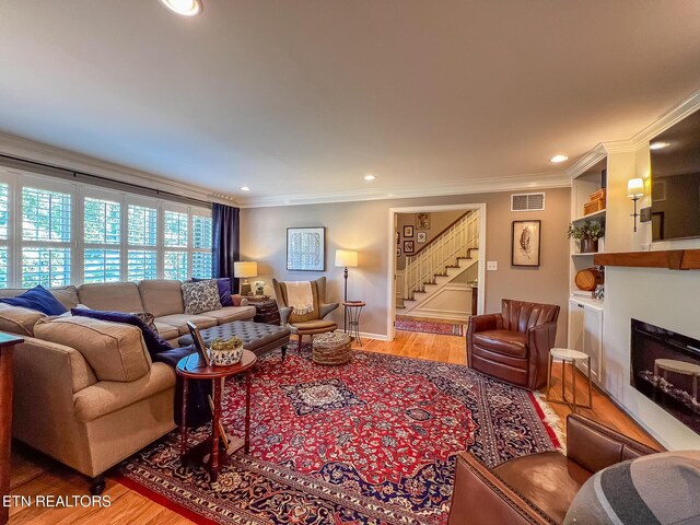 12218 Torrey Pines Pt, Knoxville, TN 37934 - living room featuring stairs, ornamental molding, a fireplace, wood finished floors, and recessed lighting