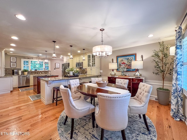 12218 Torrey Pines Pt, Knoxville, TN 37934 - dining room with a chandelier, ornamental molding, recessed lighting, light wood-style flooring, and a wainscoted wall