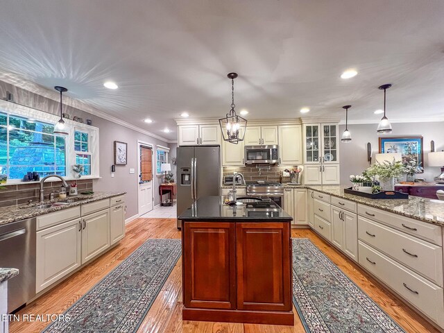 12218 Torrey Pines Pt, Knoxville, TN 37934 - kitchen featuring stainless steel appliances, ornamental molding, tasteful backsplash, glass insert cabinets, and recessed lighting