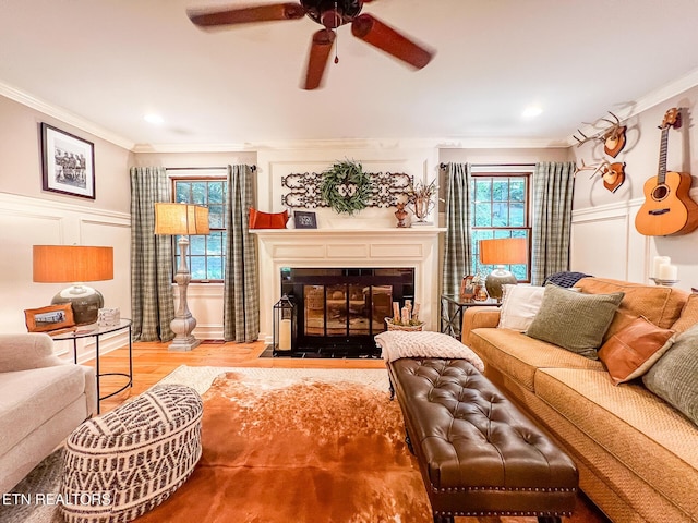 12218 Torrey Pines Pt, Knoxville, TN 37934 - living room with ornamental molding, a fireplace with flush hearth, ceiling fan, a decorative wall, and wood finished floors