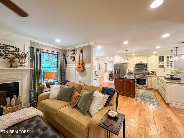 12218 Torrey Pines Pt, Knoxville, TN 37934 - living room featuring ornamental molding, light wood-style flooring, recessed lighting, and a fireplace