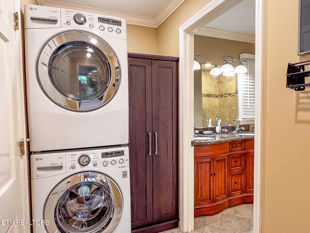 12218 Torrey Pines Pt, Knoxville, TN 37934 - laundry area featuring stacked washing machine and dryer, cabinet space, and crown molding